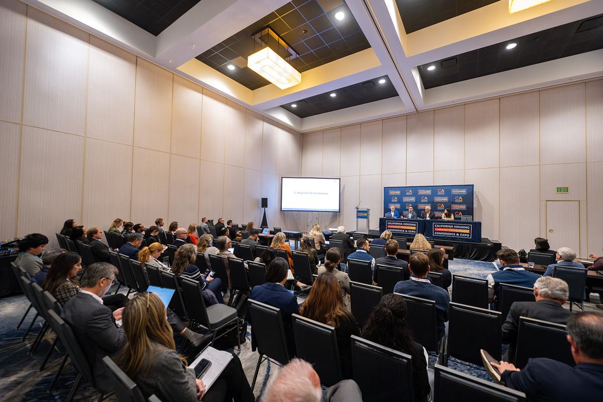 A full breakout room facing a panel