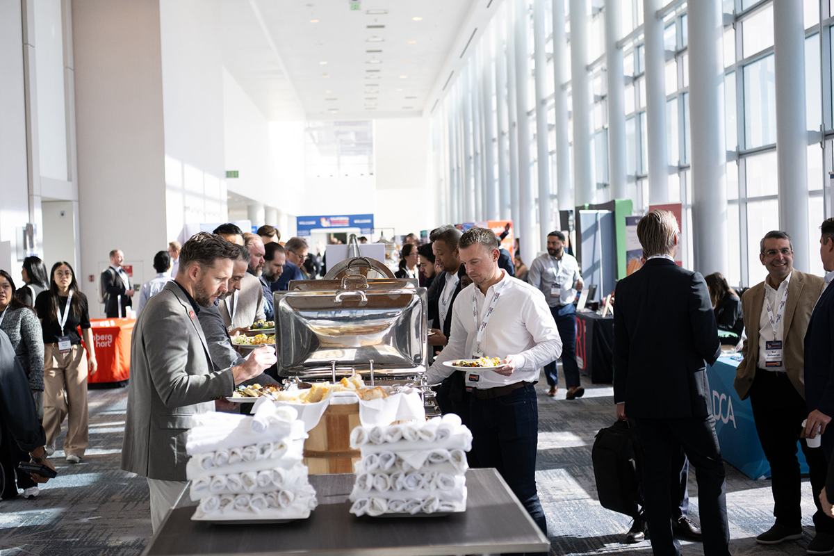 Attendees moving through the exhibit hall at a lunch break