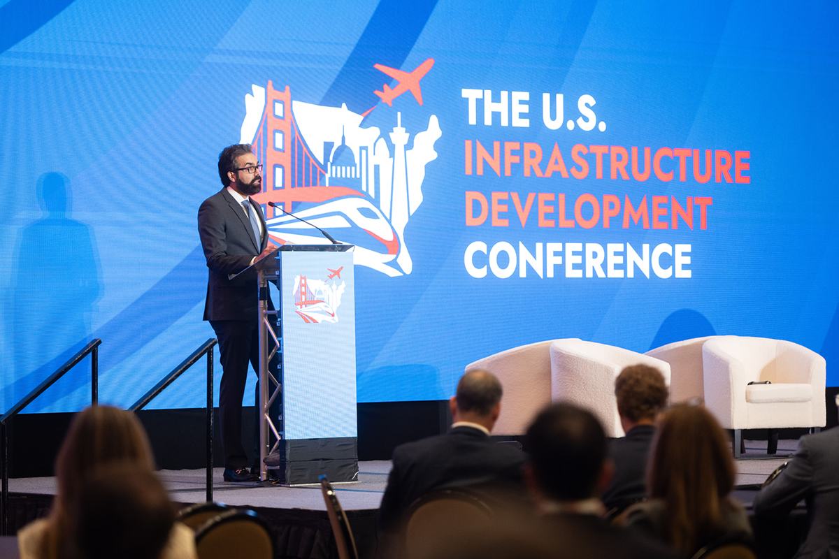 A five-person panel on the main stage in front of a full audience at the 2026 U.S. Infrastructure Development Conference